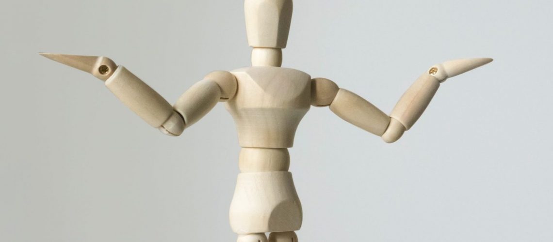 wooden figure with arms outstretched questioning